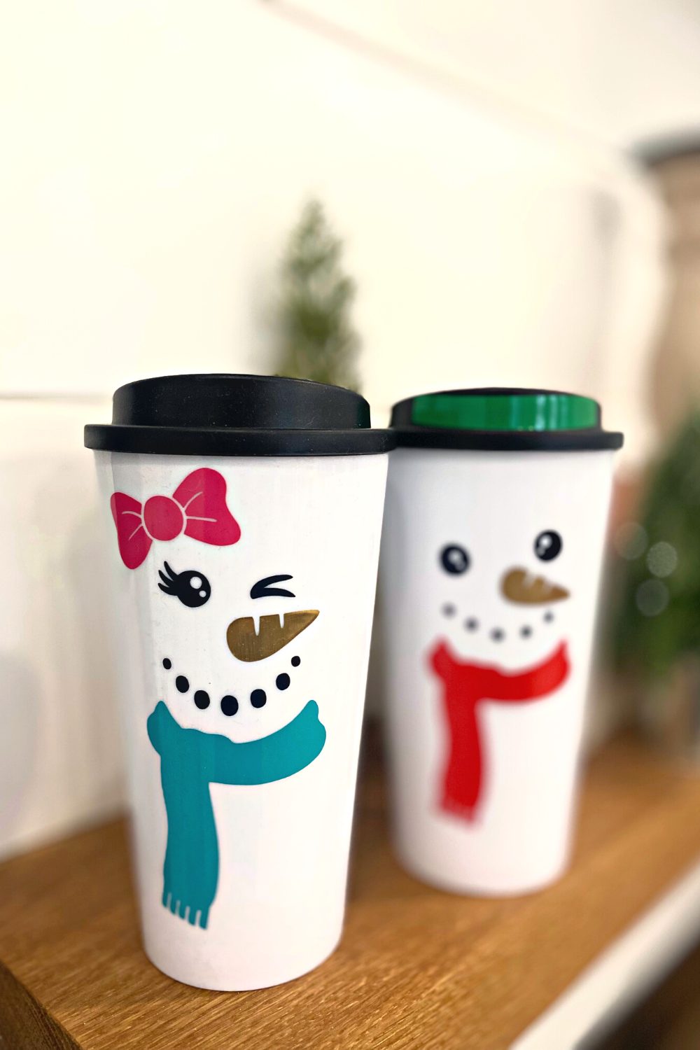 white travel coffee mugs turned into snowmen with adhesive vinyle