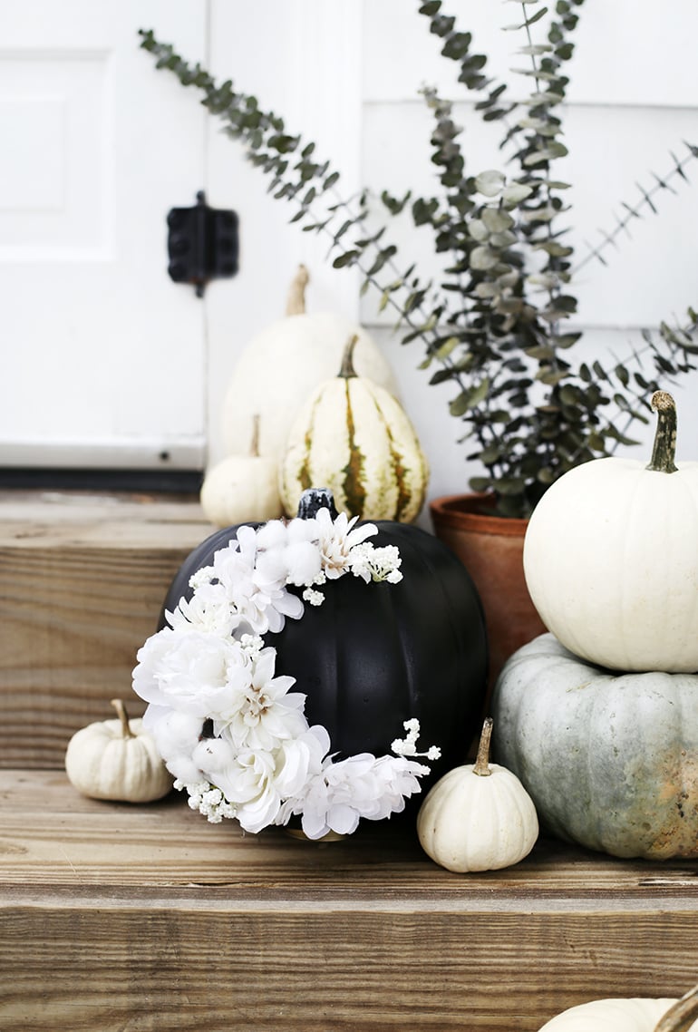 black painted pumpkin with white flowers